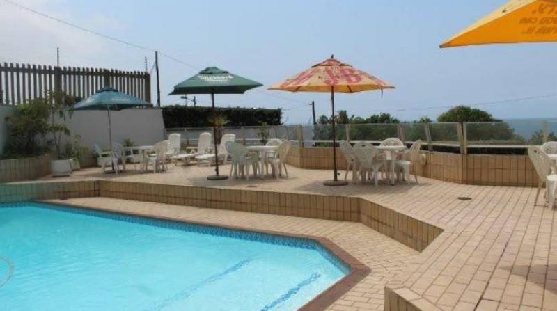 Pool deck with umbrellas overlooking the sea