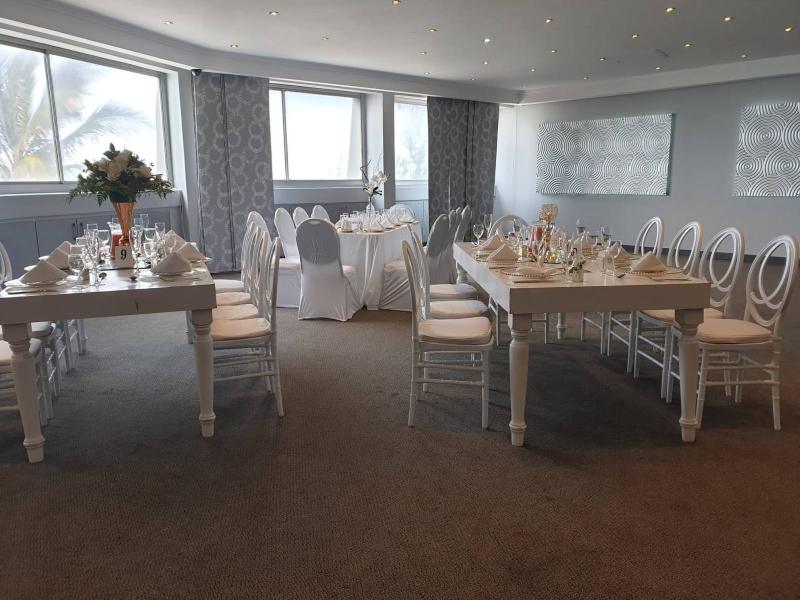 Long banquet tables in the sea-facing venue