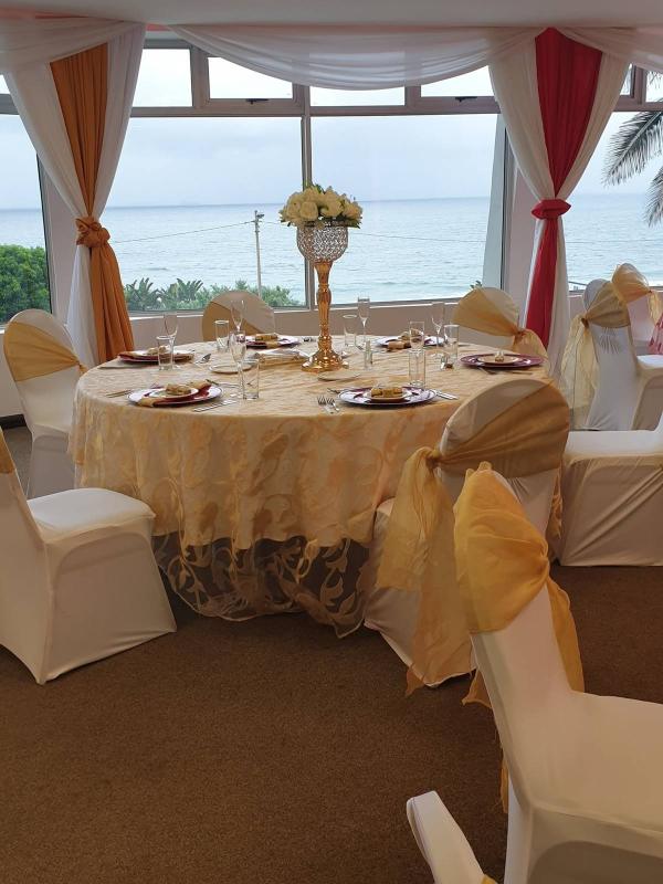 Sea-facing venue with gold wedding decor